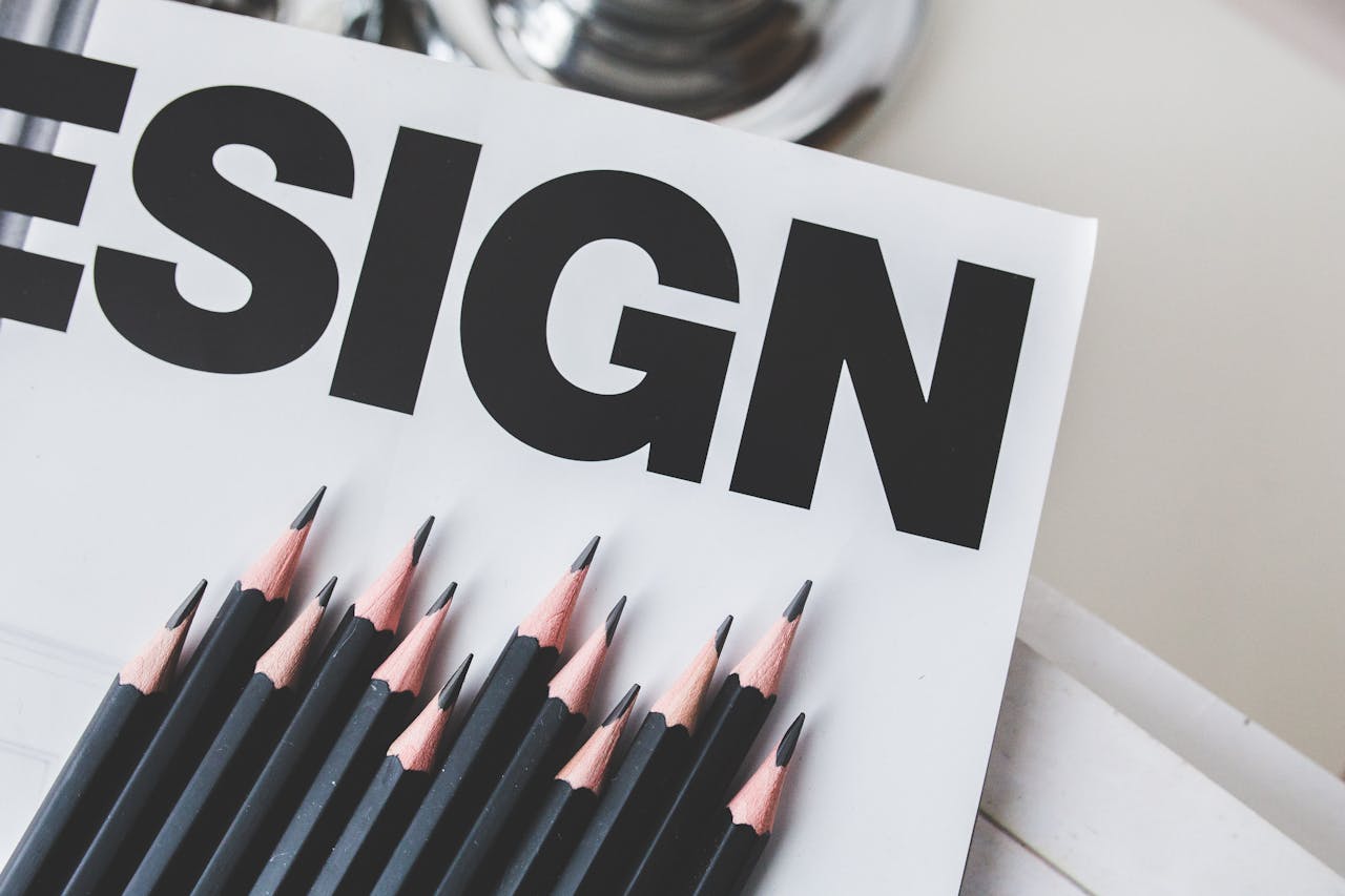 Close-up of black pencils on a design magazine cover, ideal for creative projects.